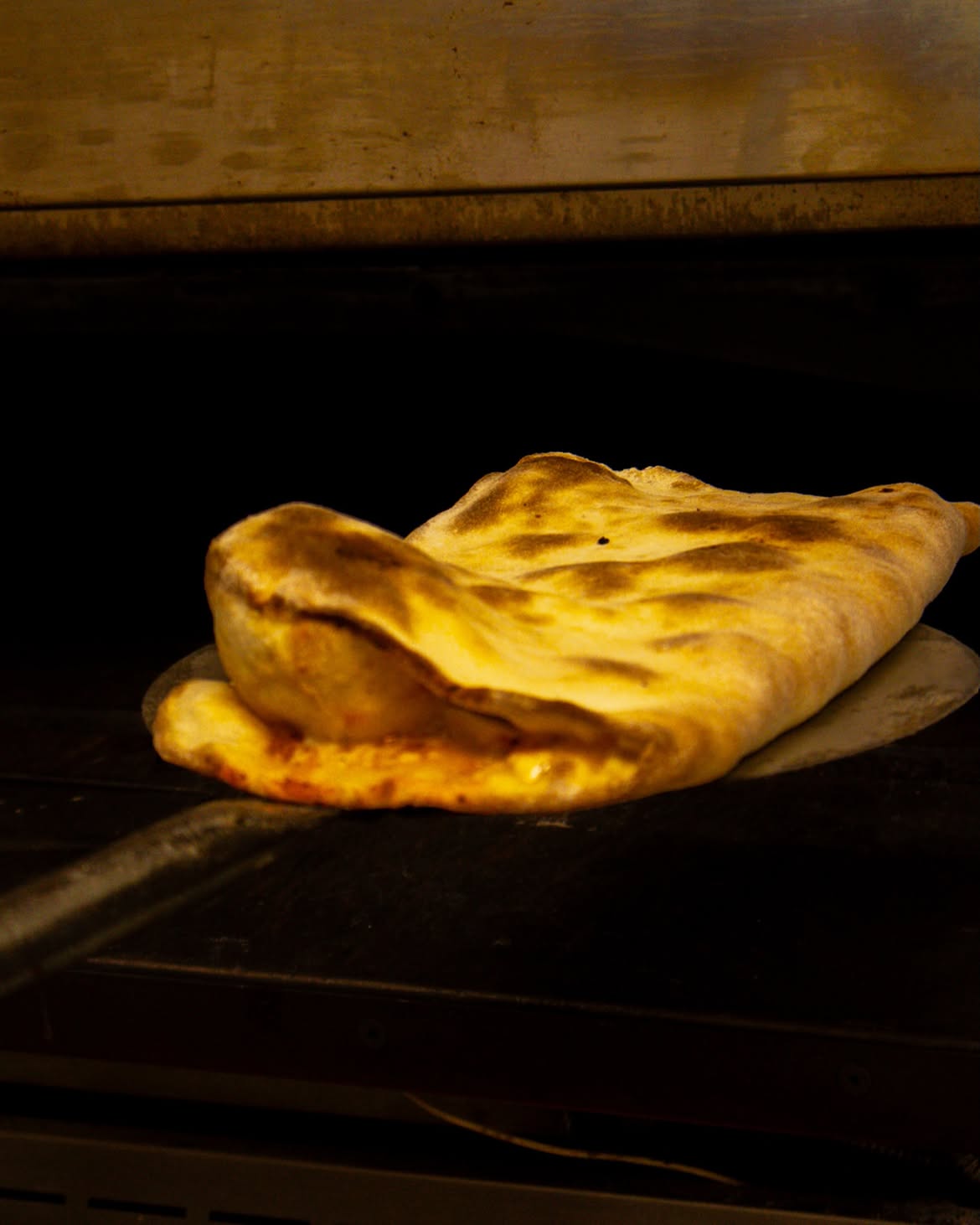 Freshly baked calzone from the oven at Ujvara Restaurant